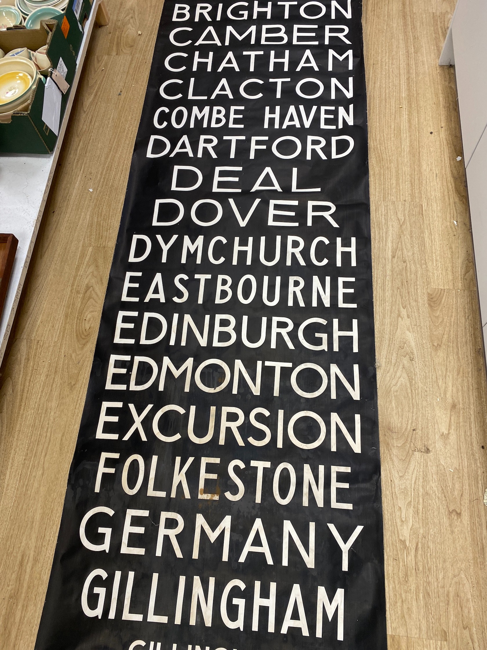 A painted canvas alphabetical list of European destinations including Sussex areas such as Brighton approximately 695x80cm